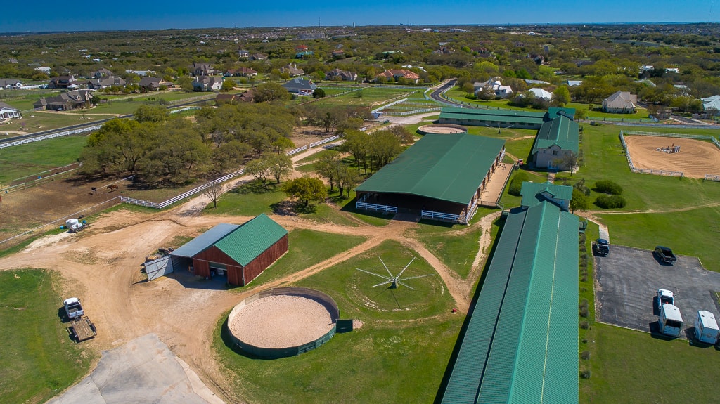 Aerial view across the riding arenas and barns at the Austin equestrian center
